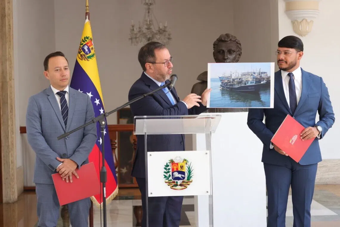 Venezuelan Foreign Minister Yvan Gil showing a picture of a fishing boat during a press conference in Caracas on Sept 13.
