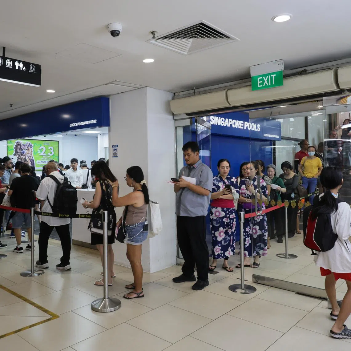 A queue at the Singapore Pools branch in Lucky Plaza on June 19.