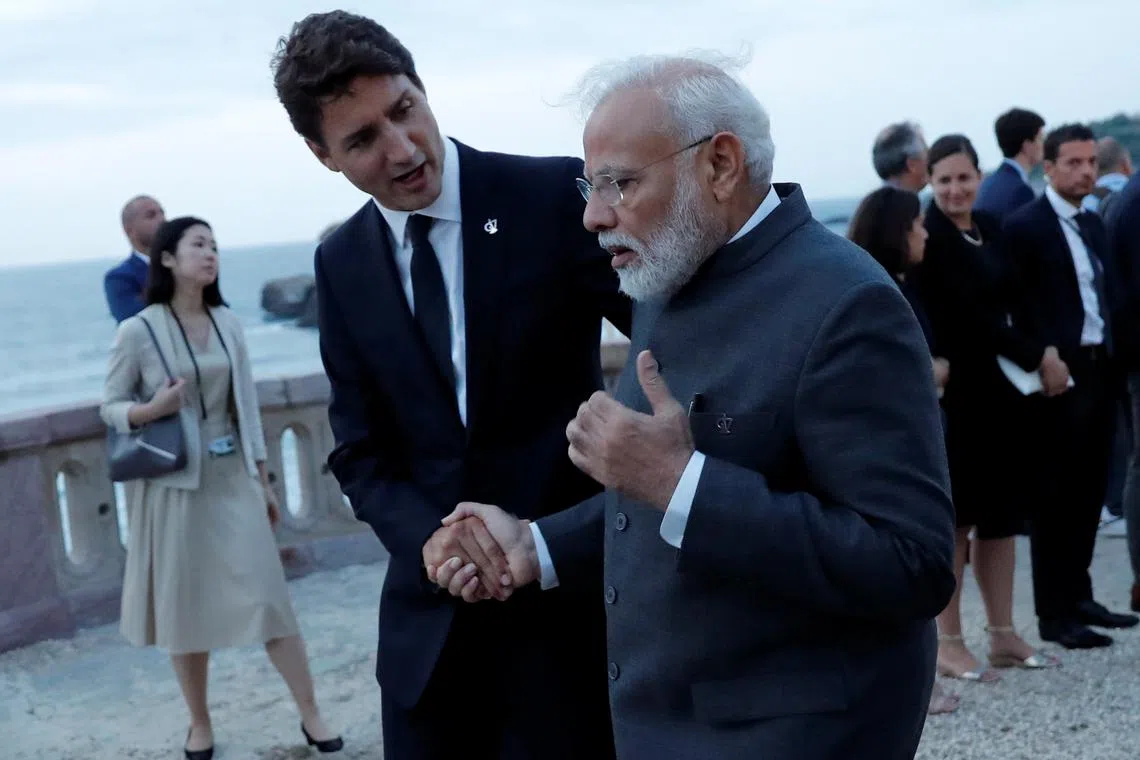 FILE PHOTO: Canada's Prime Minister Justin Trudeau shake hands with Indian Prime Minister Narendra Modi after the family photo with invited guests at the G7 summit in Biarritz, France, August 25, 2019. REUTERS/Carlos Barria/File Photo