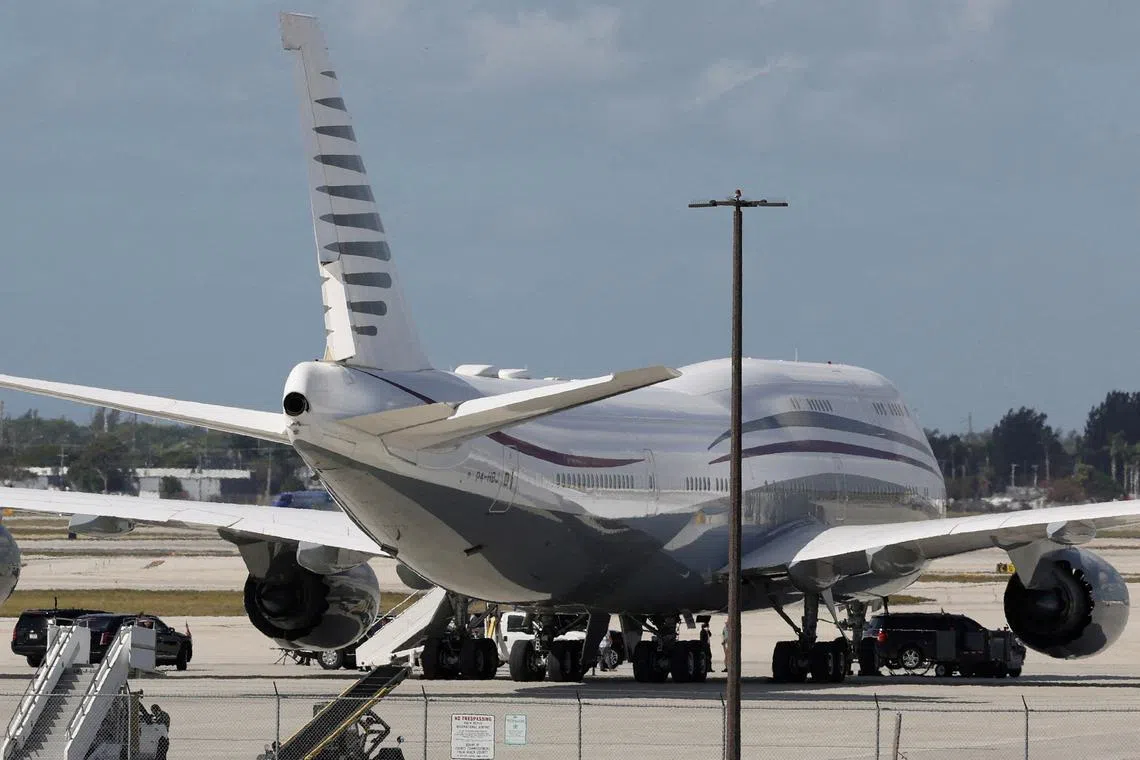 FILE PHOTO: The motorcade of U.S. President Donald Trump is parked next to a 12-year old Qatari-owned Boeing 747-8 that Trump was touring in West Palm Beach, Florida, U.S., February 15, 2025. REUTERS/Kevin Lamarque/File Photo