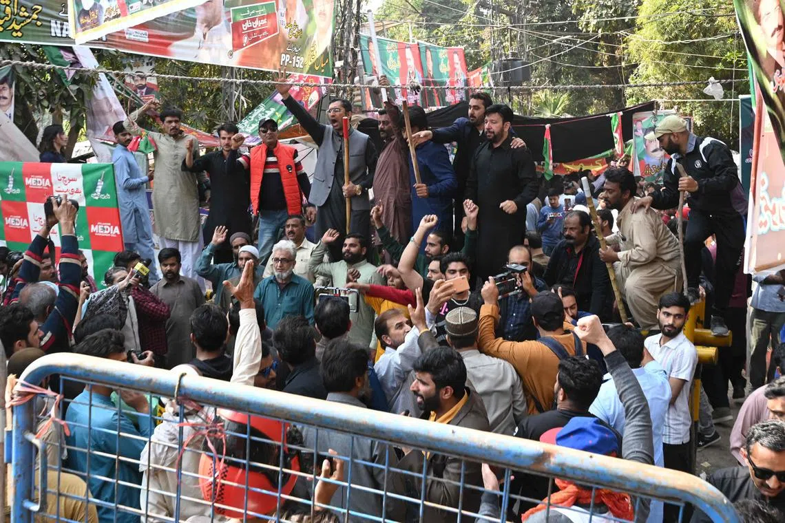Supporters of former Pakistan's prime minister Imran Khan chant slogans outside his house in Lahore on March 5, 2023. 