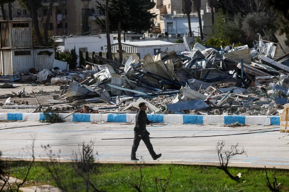 A member of the Israeli forces walks past the rubble of a dismantled structure at the Jerusalem headquarters of the United Nations Relief and Works Agency for Palestine Refugees (UNRWA), in East Jerusalem, January 20, 2026. REUTERS/Ammar Awad