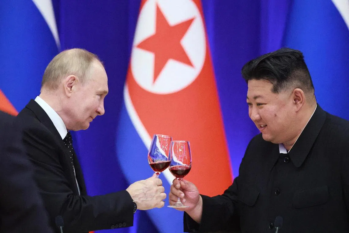 Russia's President Vladimir Putin and North Korea's leader Kim Jong Un attend a state reception in Pyongyang, on June 19.