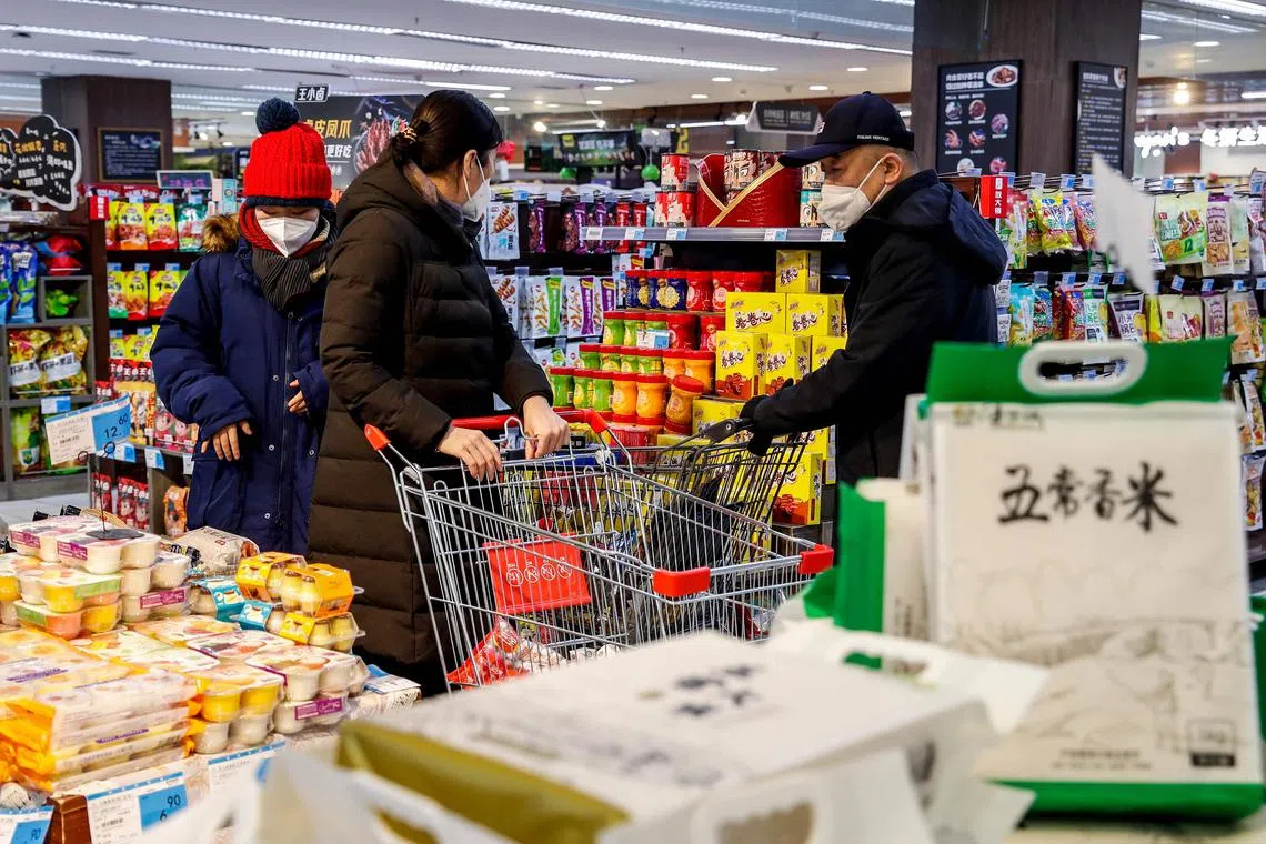People shopping at a supermarket in Urumqi, in China's north-western Xinjiang region on Dec 5, 2022, following the easing of Covid-19 restrictions in the city.