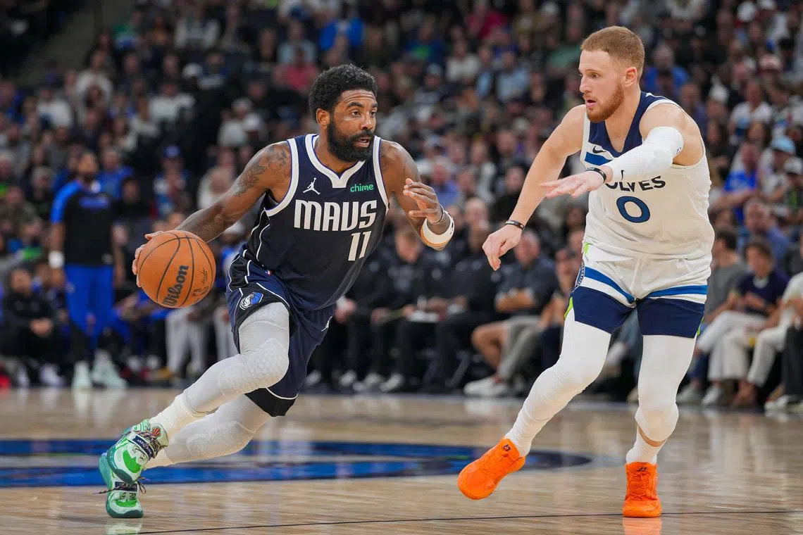 Dallas Mavericks guard Kyrie Irving dribbles against Minnesota Timberwolves guard Donte DiVincenzo in the fourth quarter at Target Centre.