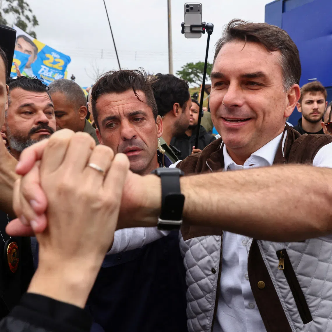 Brazilian presidential candidate Flavio Bolsonaro of the Liberal Party (PL) campaigns in the Sarandi neighborhood, one of the areas hardest hit by the historic floods in 2024, in Porto Alegre, Brazil, October 14, 2026. REUTERS/Diego Vara