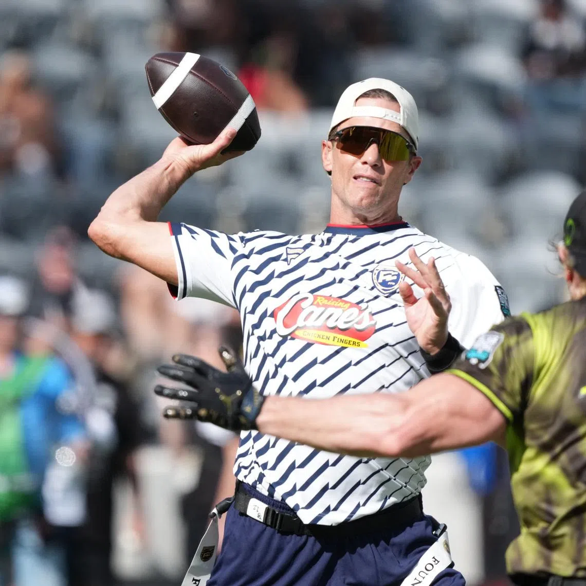 Mar 21, 2026; Los Angeles, CA, USA; Founders FFC quarterback Tom Brady (12) throws ball against Logan Paul of Wildcats FFC during the Fanatics Flag Football Classic at BMO stadium. Mandatory Credit: Kirby Lee-Imagn Images