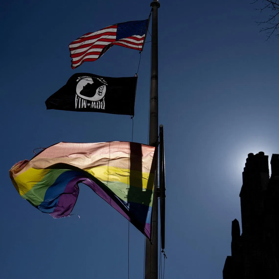 FILE PHOTO: A Pride flag flies over the Stonewall National Monument as people protest against U.S. President Donald Trump's administration's move to restrict transgender rights, in New York City, U.S., February 14, 2025. REUTERS/David 'Dee' Delgado/File Photo