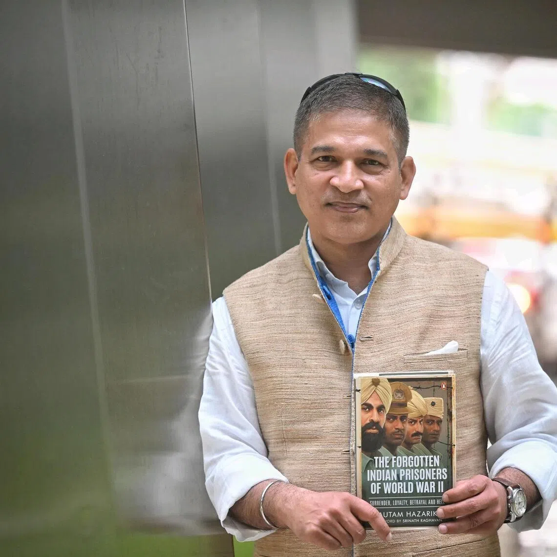 Author Gautam Hazarika, with his book, The Forgotten Indian Prisoners of World War II, at SPH on Nov 28, 2025.