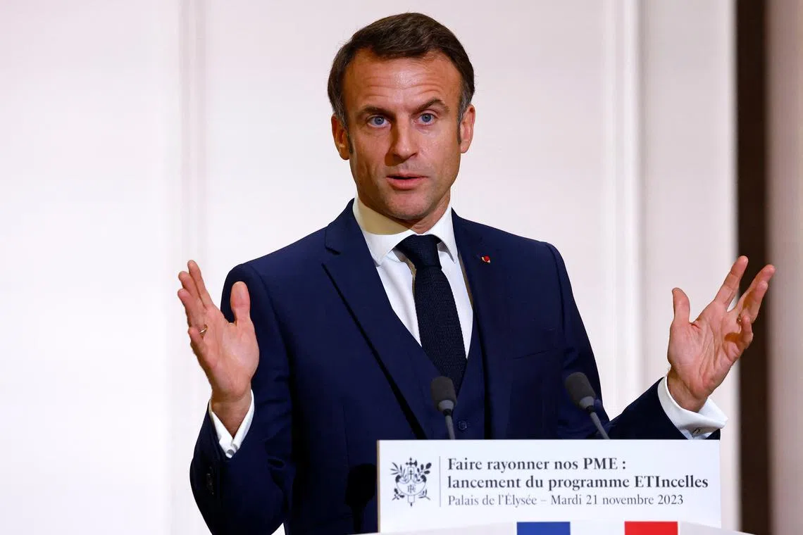 FILE PHOTO: French President Emmanuel Macron gestures as he delivers a speech during a meeting with heads of Small and Medium Enterprises (PME), members of professional federations and local elected officials to launch of the new ETIncelles program to win the export battle, at the Elysee Palace in Paris, France, November 21, 2023. REUTERS/Sarah Meyssonnier/Pool/File Photo