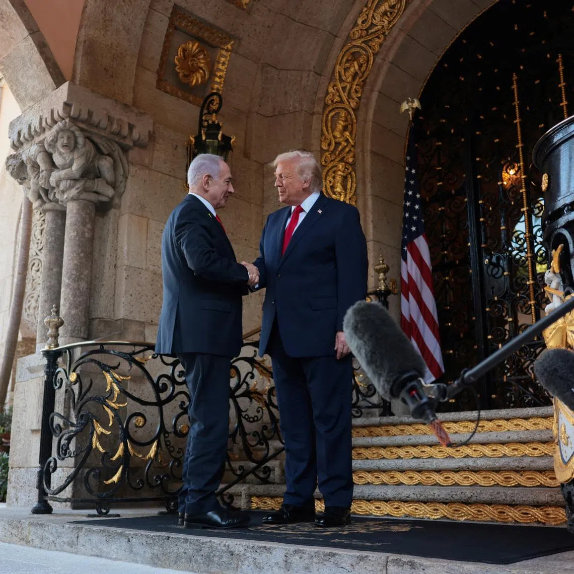 US President Donald Trump greets Israeli Prime Minister Benjamin Netanyahu in Palm Beach, Florida, in December. Israel has largely been left out of talks to reach an initial deal to halt the Iran war.
