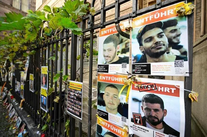 Portraits of hostages and victims of Hamas attached to a fence in Berlin ahead of the second anniversary of the militant group's Oct 7, 2023 attack on Israel.