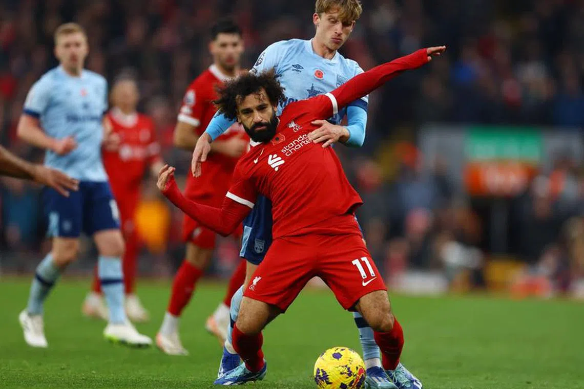Soccer Football - Premier League - Liverpool v Brentford - Anfield, Liverpool, Britain - November 12, 2023 Liverpool's Mohamed Salah in action with Brentford's Mads Roerslev REUTERS/Molly Darlington