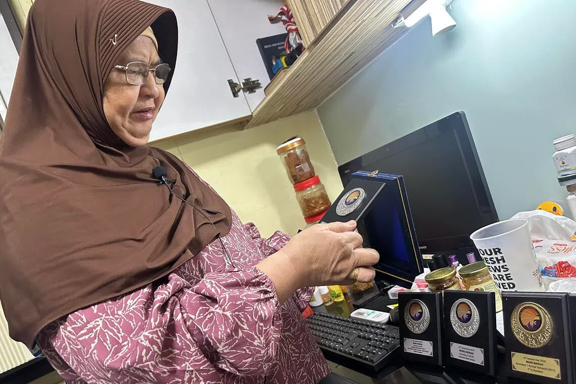 Madam Rahimah Lee Abdullah showed ST Mohd Ridwan's school medals over the years, which she has kept away since he died in July 2021 in an accident at a Bedok basketball court.
