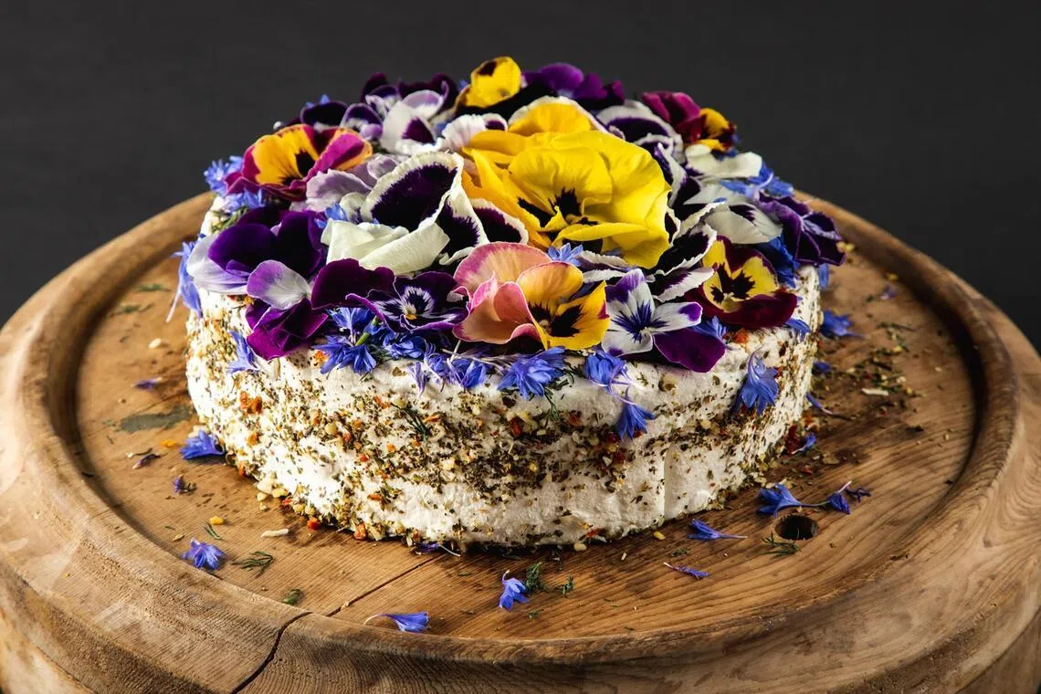 The Monet goat cheese is adorned with an explosion of colourful florals.