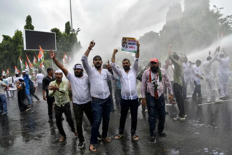 Police personnel use a water cannon to disperse India’s Opposition Congress party supporters shouting slogans against India’s Chief Election Commissioner Gyanesh Kumar, demanding his resignation during a protest in Patna on Sept 25.