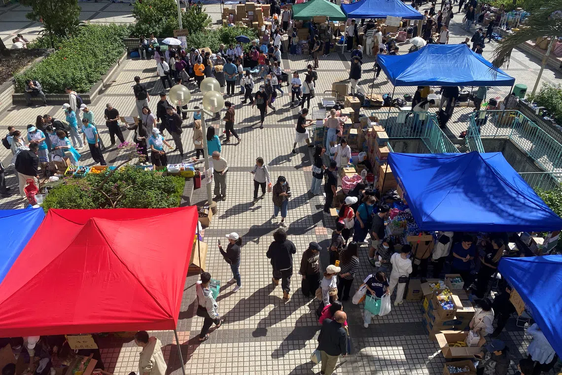 People visit a resource collection point set up by volunteers to provide supplies for residents impacted by the deadly fire, near the Wang Fu Court housing complex in Tai Po, Hong Kong, China November 28, 2025. REUTERS/Jessie Pang