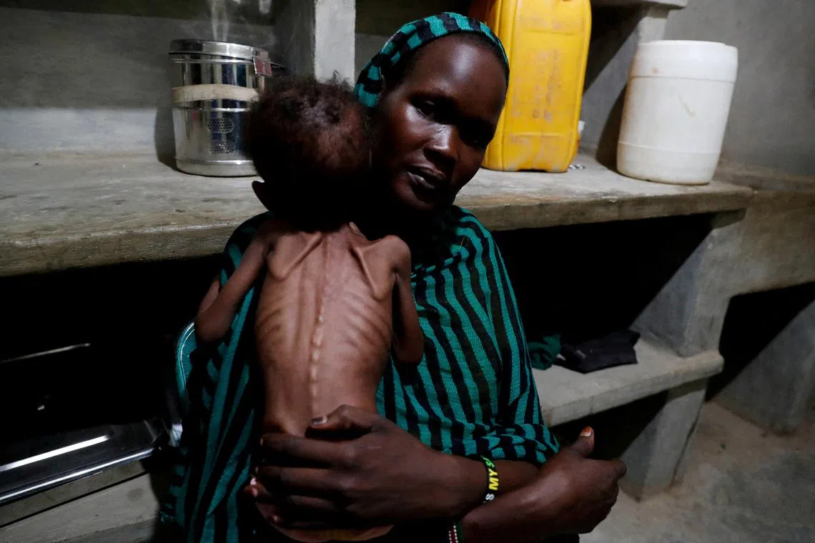 FILE PHOTO: Robaika Peter, 25, holds her severely malnourished child at the paediatric ward of the Mother of Mercy Hospital in Gidel, South Kordofan, Sudan June 25, 2024. REUTERS/Thomas Mukoya/File Photo
