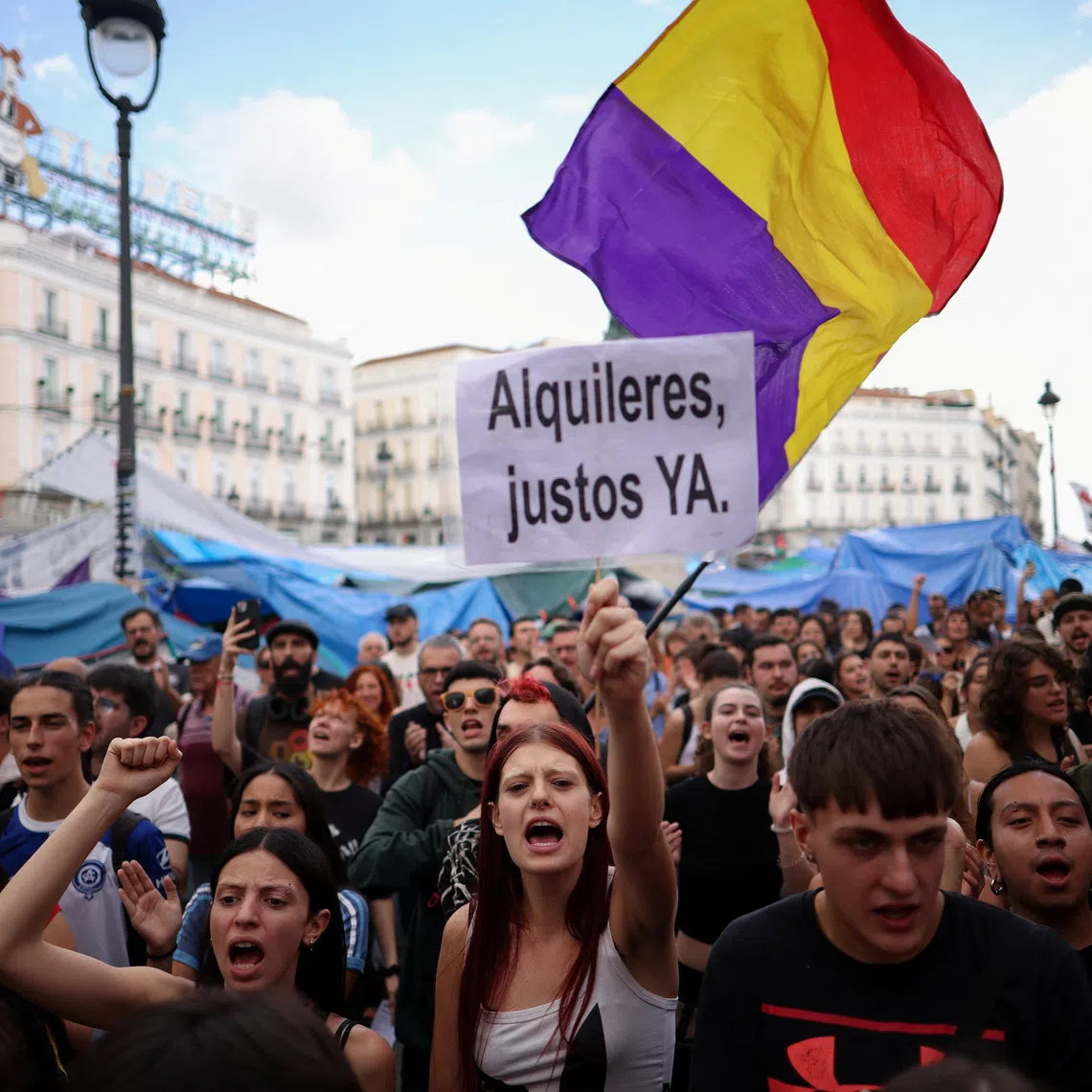 A demonstrator holding a sign with the slogan ‘Fair rents now’ during a protest at Puerta del Sol in Madrid on Oct 2.