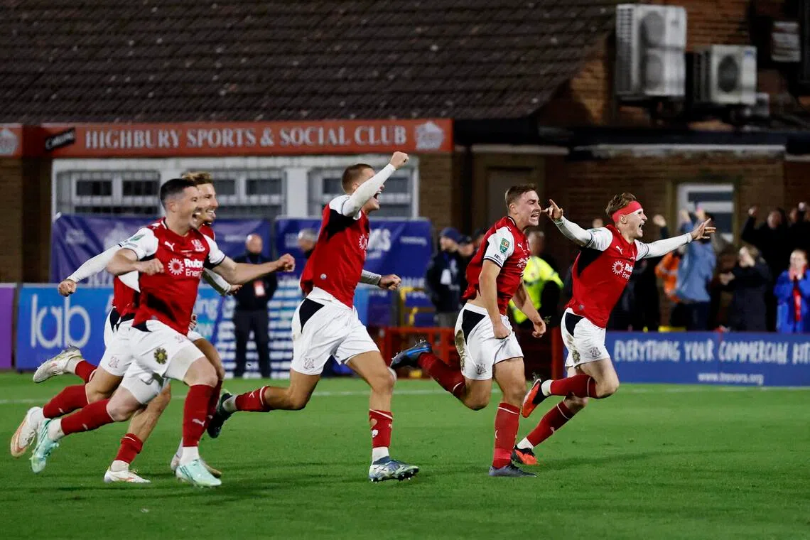 Fleetwood Town’s players celebrate after beating Arsenal on penalties in the League Cup fourth round.