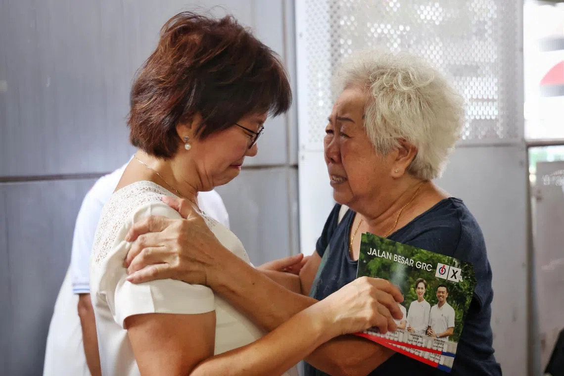 An emotional Madam Yip Lum Fong, 83, rushed to hug Kampong Glam incumbant Denise Phua during the latter's walkabout with the PAP team at North Bridge Road Market and Food Centre on April 30, 2025. Madam Yip told Ms Phua to take care of her own health first before she took care of her residents. ST PHOTO: JASON QUAH