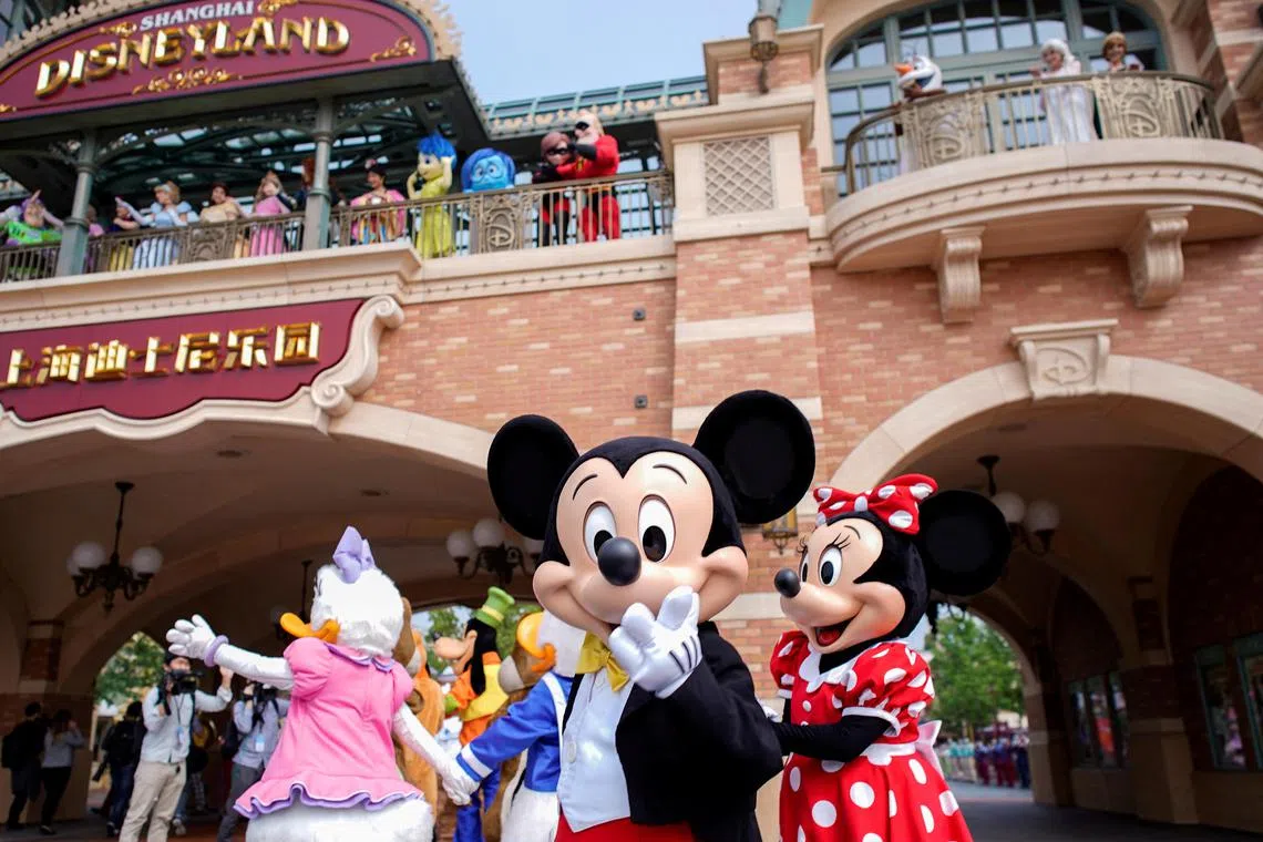 FILE PHOTO: Disney characters Mickey Mouse and Minnie Mouse, among others, greet visitors at Shanghai Disney Resort at the Shanghai Disneyland theme park in Shanghai, China May 11, 2020. REUTERS/Aly Song/File Photo