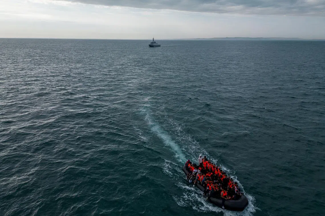 FILE PHOTO: In this drone view, an inflatable dinghy carrying migrants makes its way towards England in the English Channel, Britain, August 6, 2024. REUTERS/Chris J. Ratcliffe/File Photo