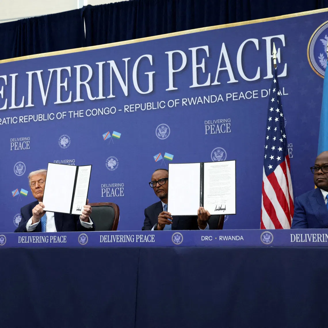 FILE PHOTO: U.S. President Donald Trump, President of the Democratic Republic of the Congo Felix Tshisekedi and President of Rwanda Paul Kagame hold a signed document during a signing ceremony at the U.S. Institute of Peace in Washington, D.C., U.S., December 4, 2025. REUTERS/Kevin Lamarque/File Photo