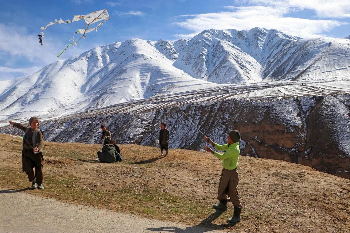 Afghan boys flying kites on a hilltop in Badakhshan on March 14, 2024. 