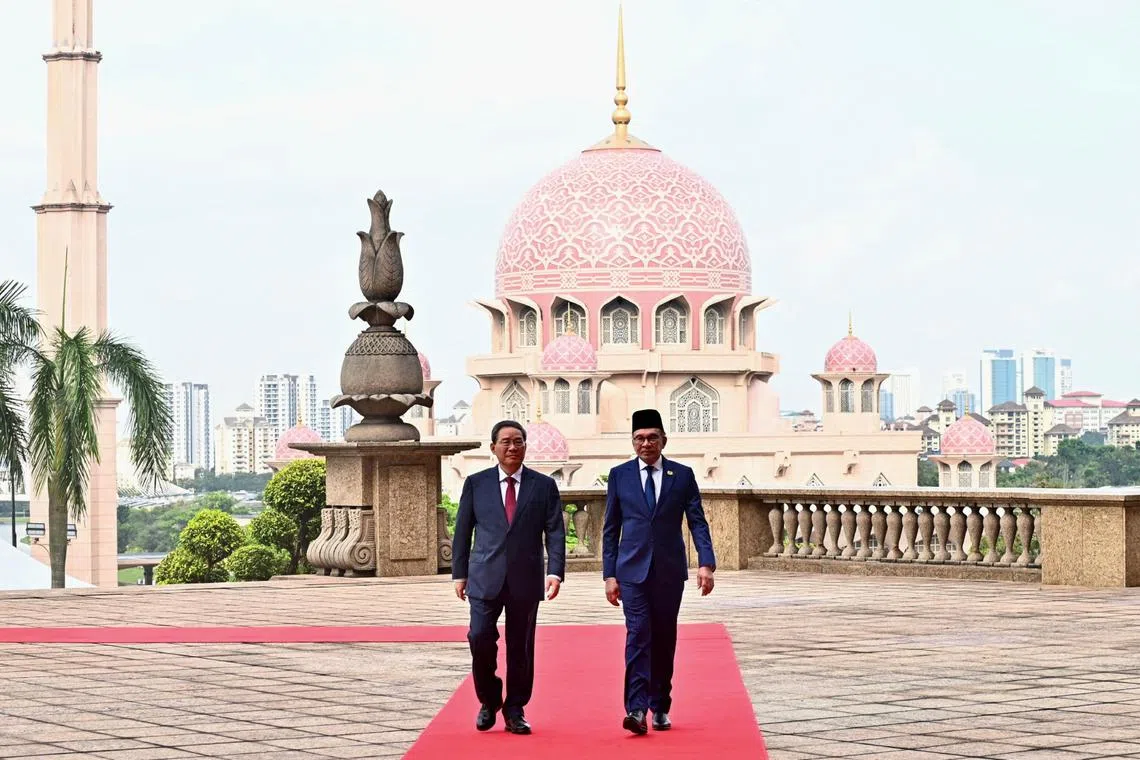 China's Premier Li Qiang with Malaysian Prime Minister Anwar Ibrahim in Putrajaya on June 19, during a visit to commemorate 50 years of bilateral ties.