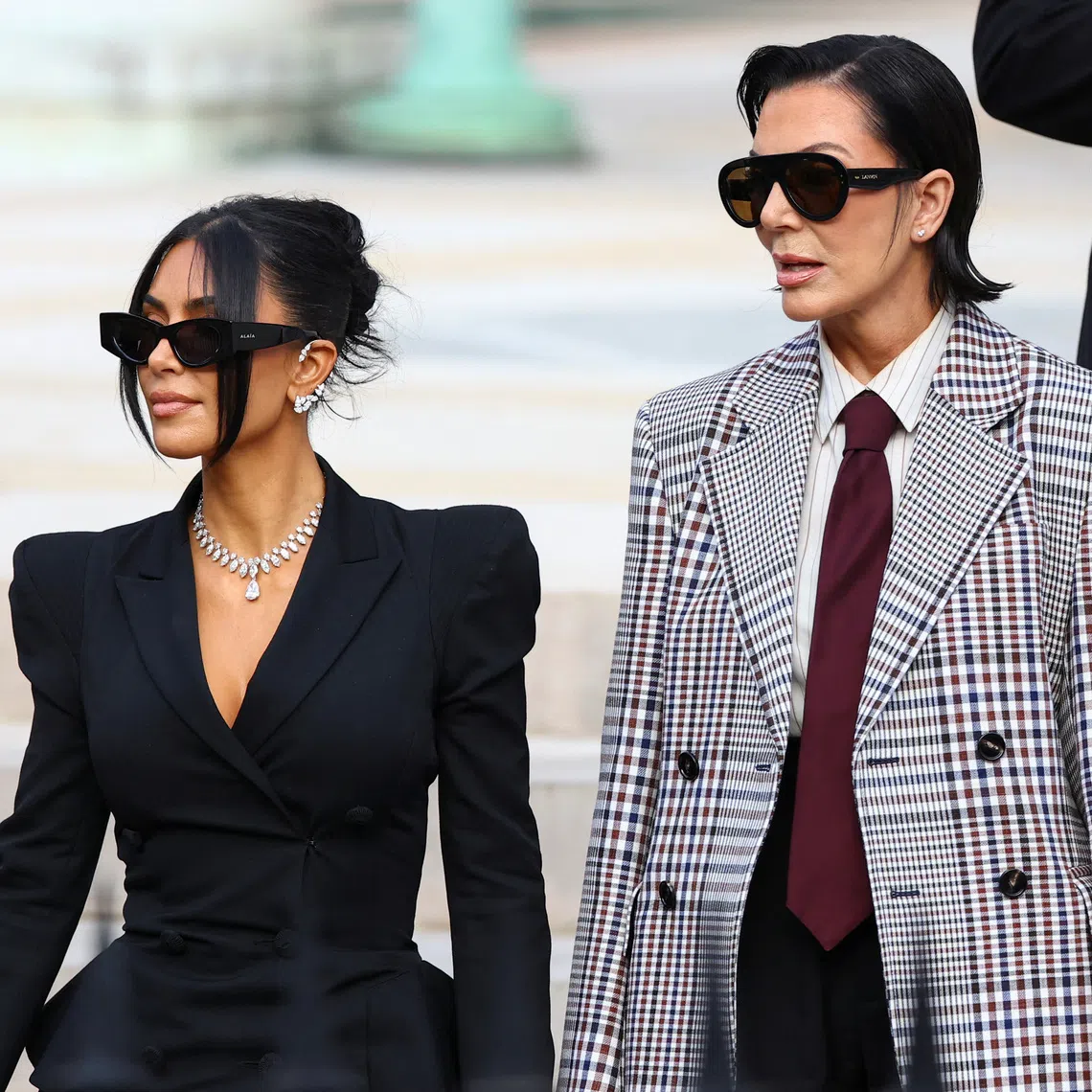 Kim Kardashian (left), accompanied by her mother and manager, Kris Jenner, leaving the courthouse after a trial in Paris, on May 13, 2025.