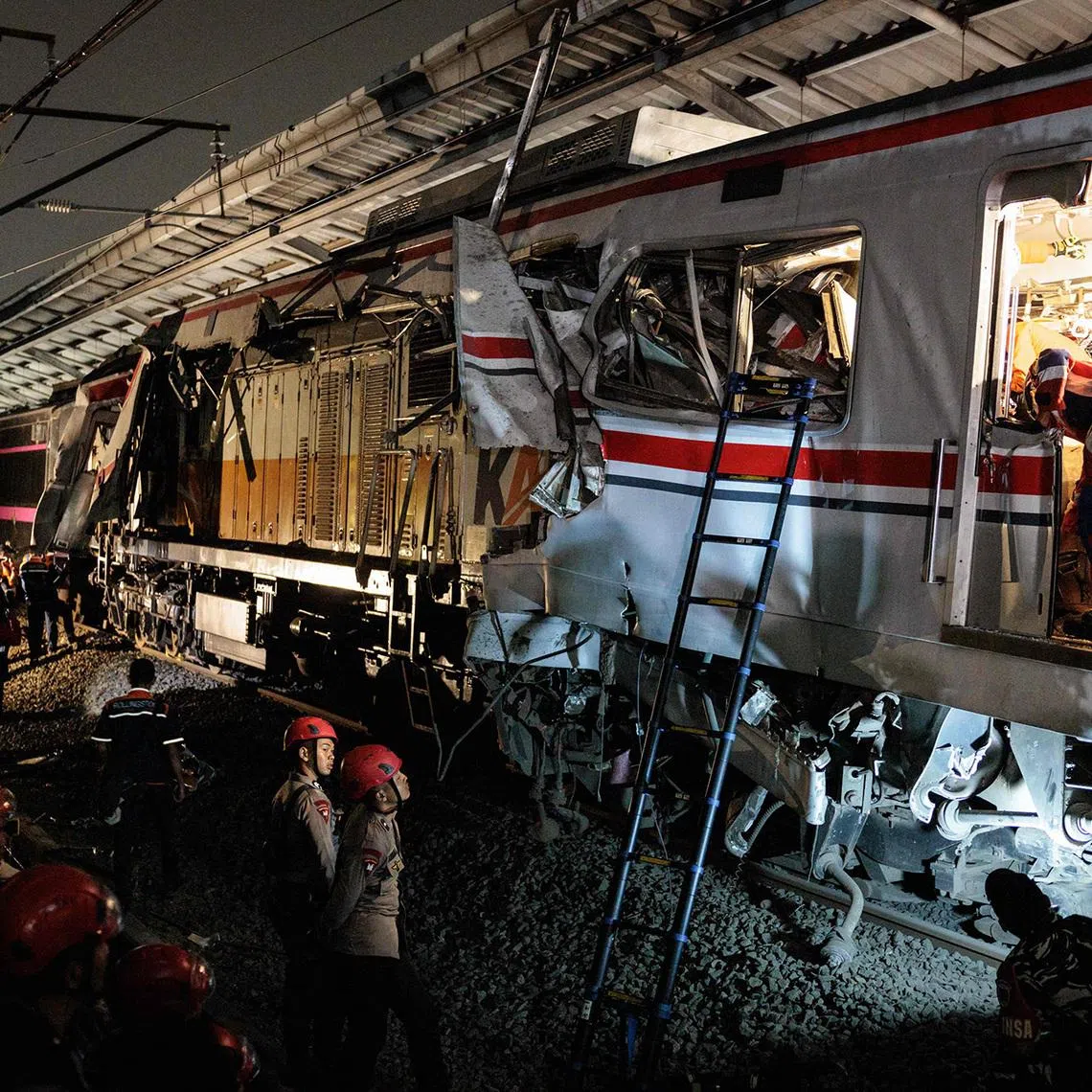 Security and emergency personnel at the site of a train collision on April 28, 2026.  Rescuers working to save survivors trapped inside a carriage after a passenger train locomotive pierced through the rear car of a commuter train at Bekasi Timur station in Bekasi, West Java, on April 27.