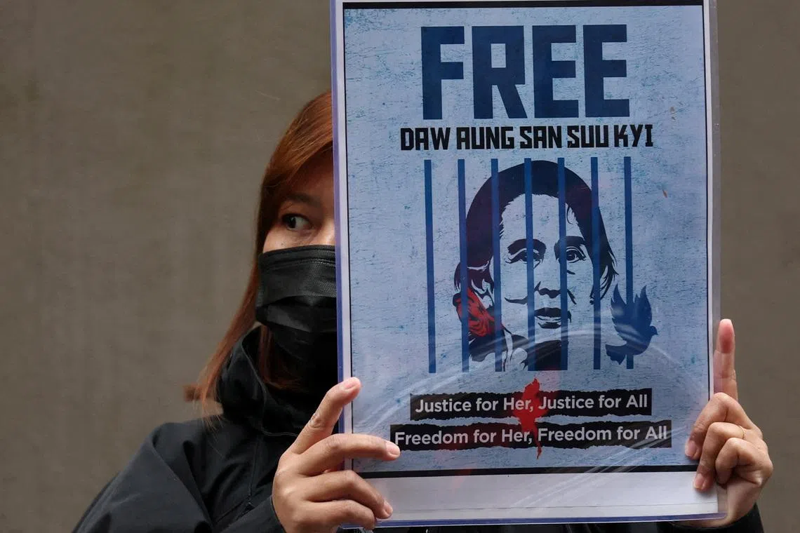 FILE PHOTO: A Myanmar protester living in Japan holds a placard of Myanmar's detained former leader, Aung San Suu Kyi, during a rally denouncing an upcoming election led by the military junta, outside Myanmar's embassy in Tokyo, Japan, December 14, 2025. REUTERS/Issei Kato/File Photo