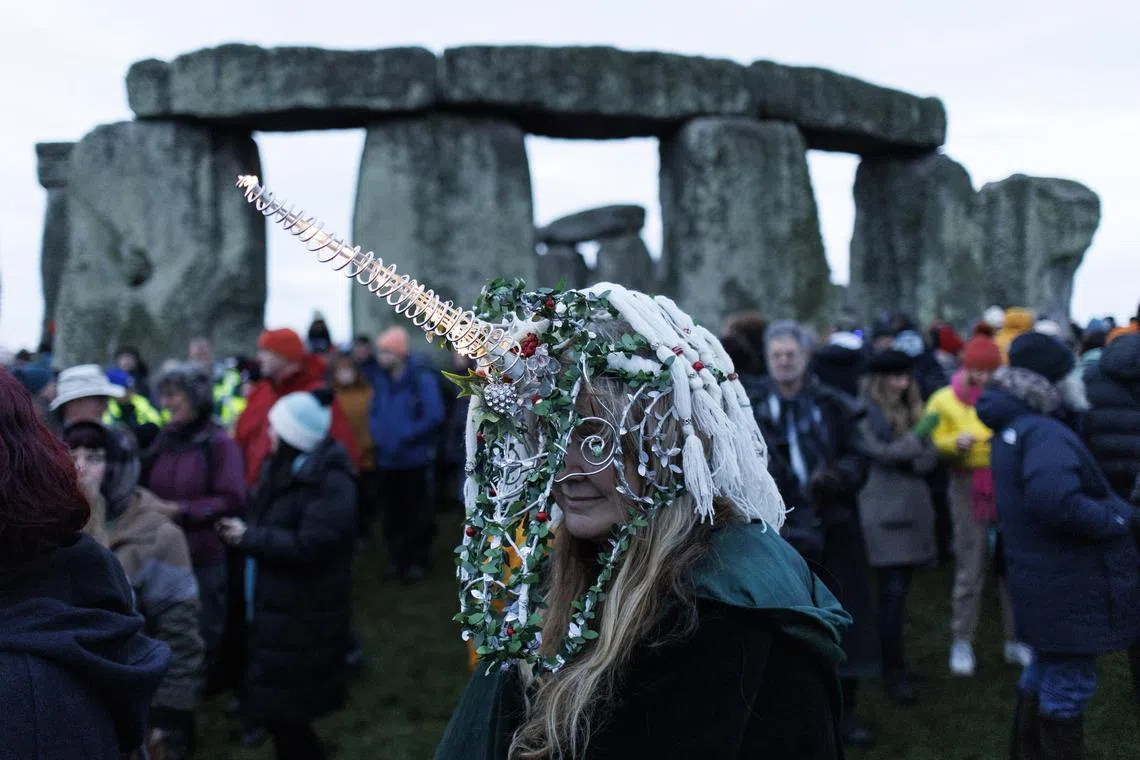 A reveller takes part in the winter solstice celebrations at the ancient Stonehenge monument in Wiltshire, Britain.