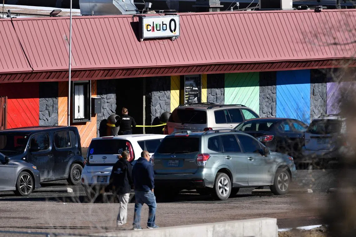 Law enforcement officers walk through the parking lot of Club Q, after a shooting, on Nov 20, 2022.