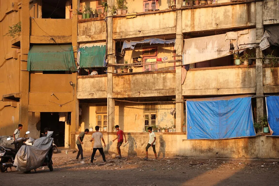 Children playing football outside the Worli dairy quarters building on Feb 24, 2023. 