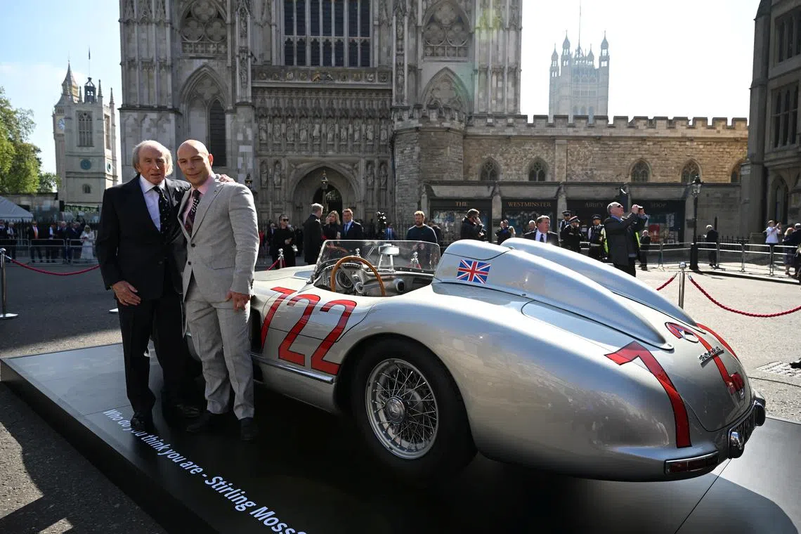Former F1 driver Jackie Stewart and Elliot Moss stand near a vintage sports car formerly piloted by Sir Stirling Moss at a service of Thanksgiving for Sir Stirling Moss's life and work at Westminster Abbey, London, Britain, May 8, 2024.  Paul Grover/Pool via REUTERS