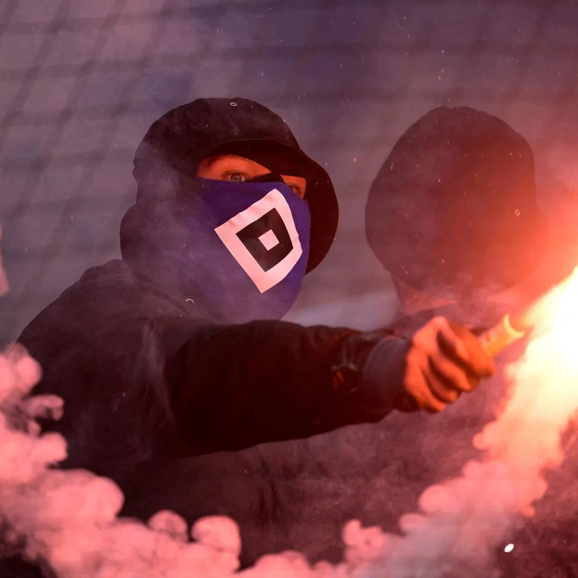 Soccer Football - Bundesliga - Werder Bremen v Hamburg SV - Weserstadion, Bremen, Germany - April 18, 2026 A Hamburg SV fan holds a flare in the stands during the match REUTERS/Fabian Bimmer