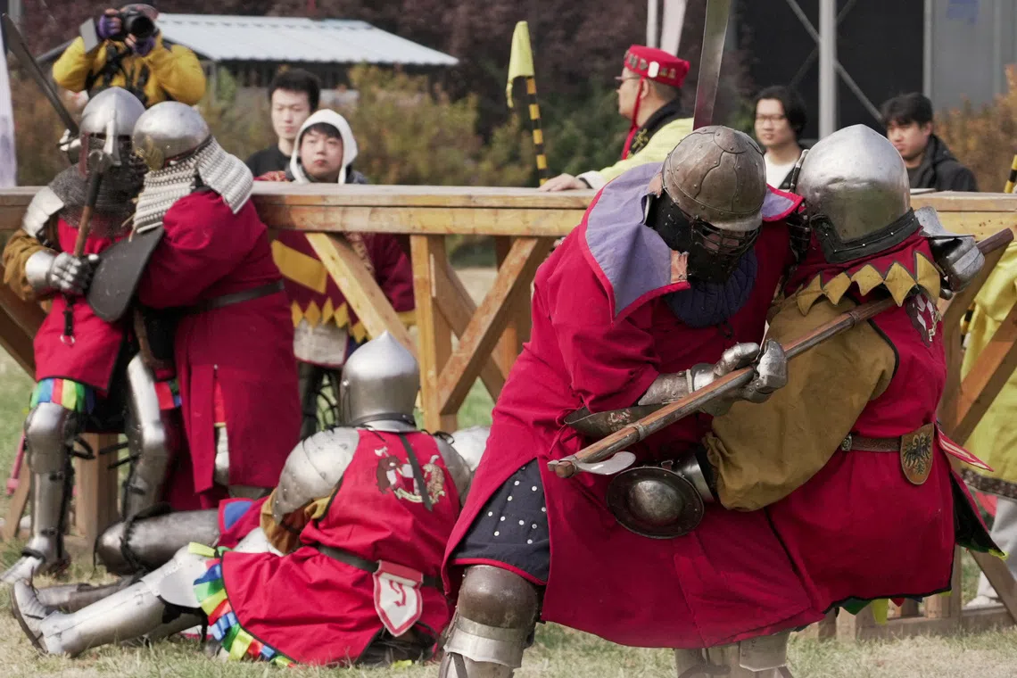 Spectators watch as participants dressed in historical plate armour fight during the Quanjia Fighting Open Championship, a full-contact medieval combat tournament in Beijing, China, October 24, 2026. REUTERS/Mandy Leong