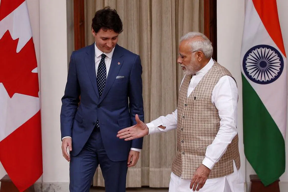 FILE PHOTO: Indian Prime Minister Narendra Modi (R) extends his hand for a handshake with his Canadian counterpart Justin Trudeau during a photo opportunity ahead of their meeting at Hyderabad House in New Delhi, India, February 23, 2018. REUTERS/Adnan Abidi/File Photo