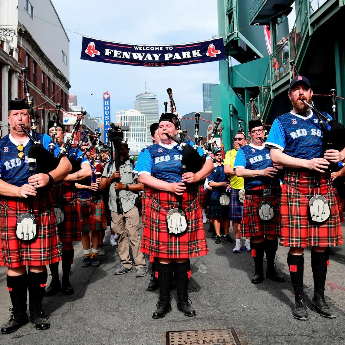 Soccer Football - FIFA World Cup 2026 - Scotland's Tartan Army march to Boston's Fenway Park baseball stadium - Boston, Massachusetts, U.S. - June 14, 2026 Scotland fans wearing kilts and playing the bagpipes during the march to Fenway Park IMAGN IMAGES via Reuters/Bob Dechiara