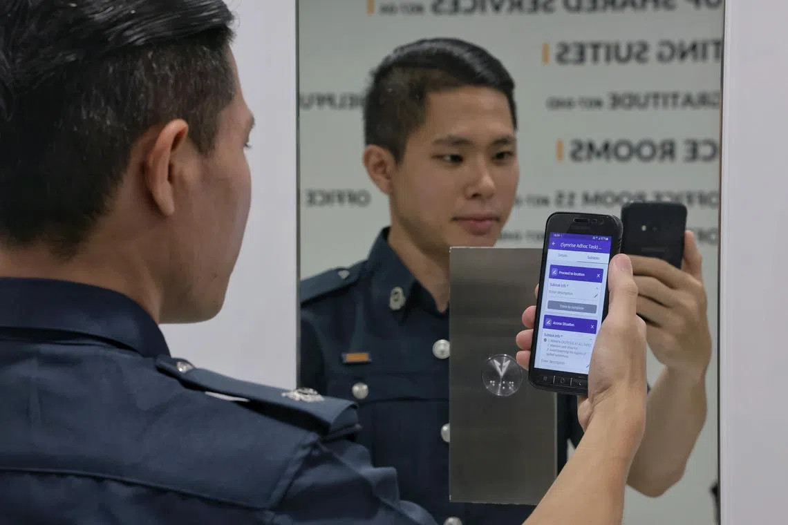 Certis Cisco auxiliary police officer ASP (APF) Colin Ng, 32, with the Argus interface through which officers on the ground send incident reports, during the official launch of the Certis-SUTD AI Literacy and Digital Mastery Programme at Certis Commonwealth on Oct 11, 2024. The programme aims to empower 5,000 security professionals, managers, supervisors and Auxiliary Police Officers (APOs) on how to use AI at work by 2027.