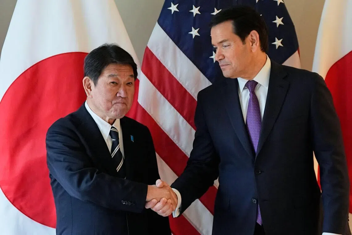 US Secretary of State Marco Rubio (R) and Japan's Foreign Minister Toshimitsu Motegi shake hands as they met on the sidelines of the 62nd Munich Security Conference on Feb 14.