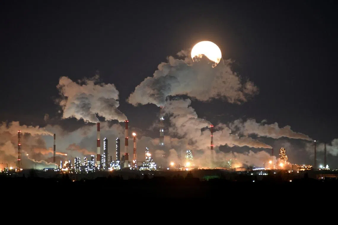 FILE PHOTO: A full moon rises over Gazprom Neft's oil refinery in Omsk, Russia,  February 10, 2020. REUTERS/Alexey Malgavko/File Photo