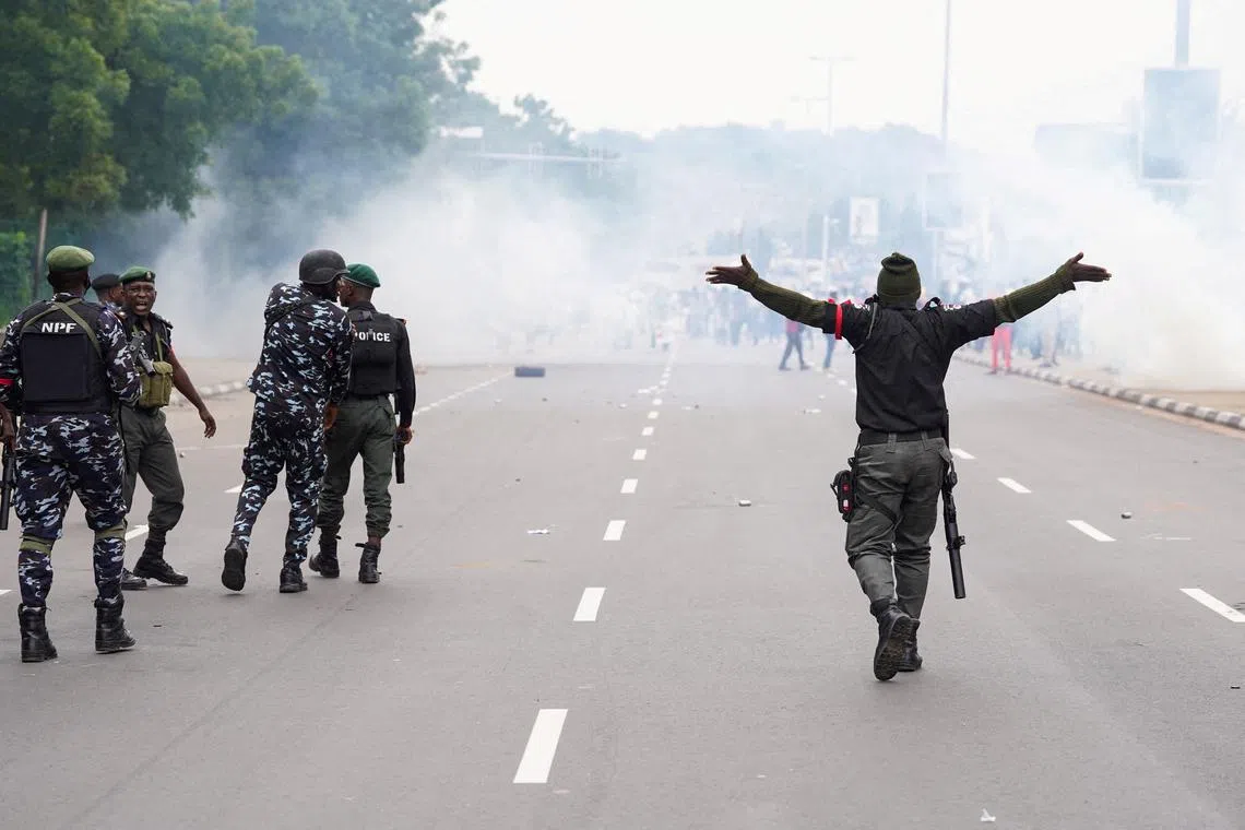 FILE PHOTO: Nigerian security forces lob teargas canisters to disperse demonstrators who protest against bad governance and economic hardship in Abuja, Nigeria, August 1, 2024. REUTERS/Marvellous Durowaiye/File Photo