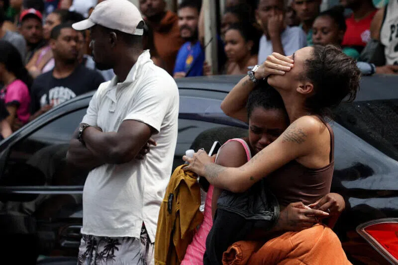 Mourners react as people gather around bodies, the day after a deadly police operation against drug trafficking at the favela do Penha, in Rio de Janeiro, Brazil, on Oct 29.