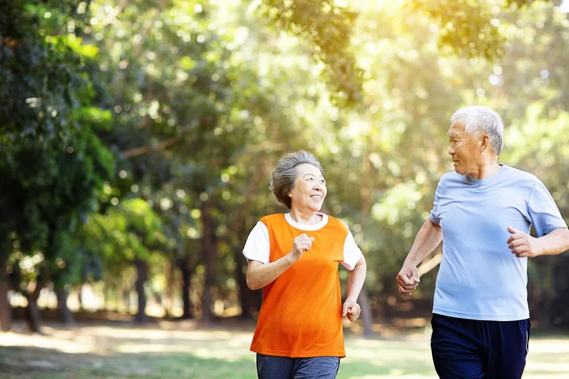happy Senior couple running in the park