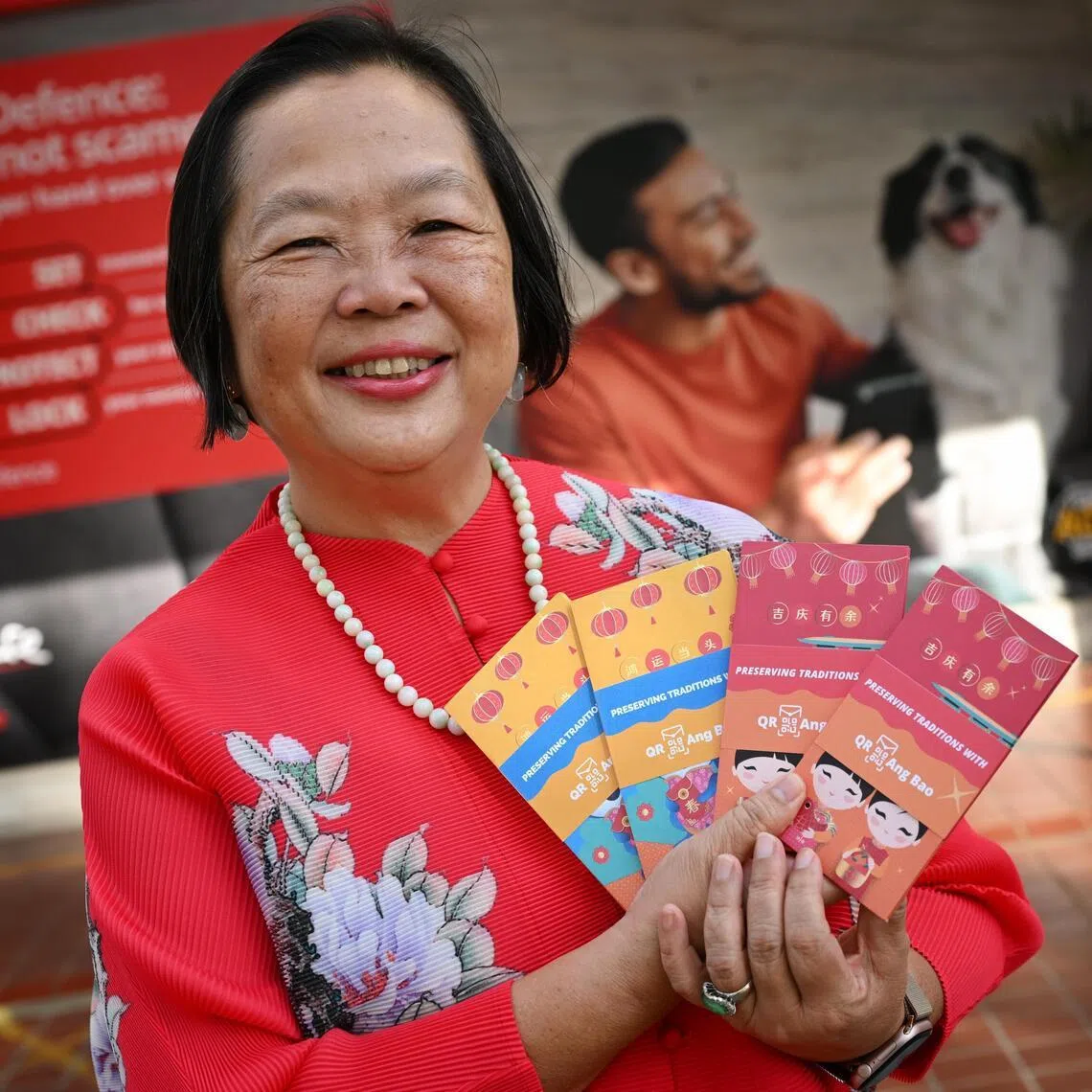 Ms Anna Leong who has been using the DBS’ QR hongbaos since its introduction in 2019, at the bank's Kovan branch on Feb 3.