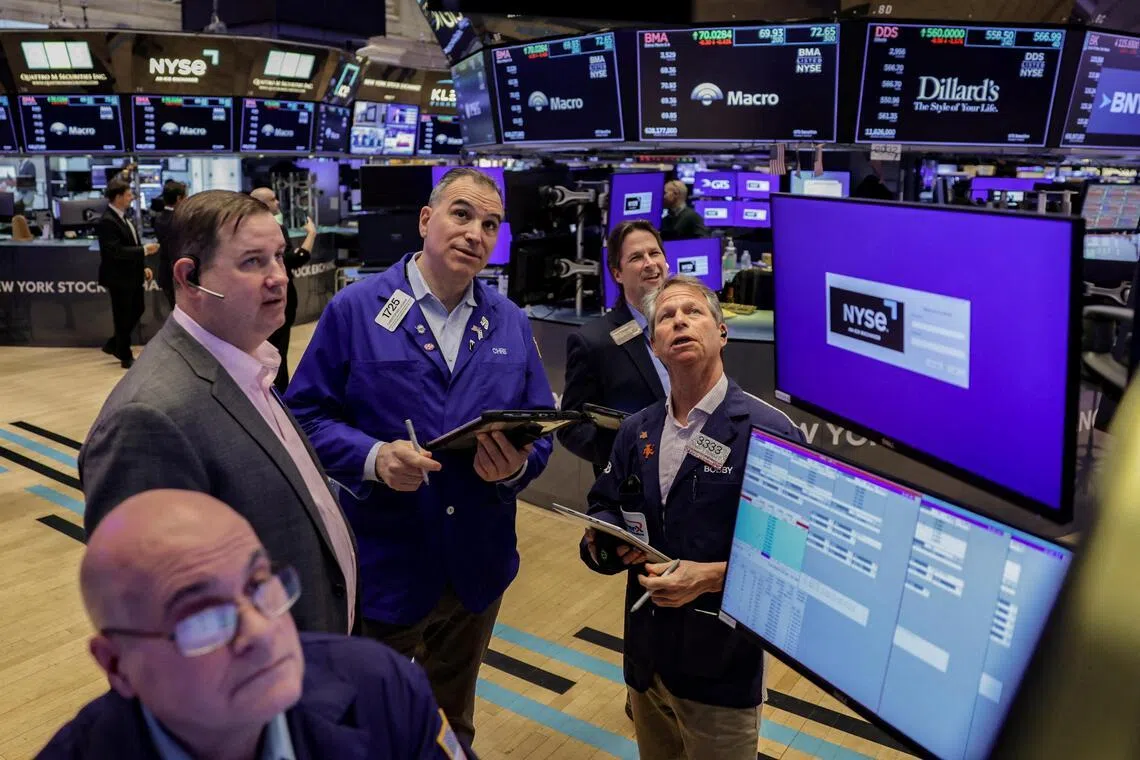 Traders work on the floor at the New York Stock Exchange in New York City on March 24.