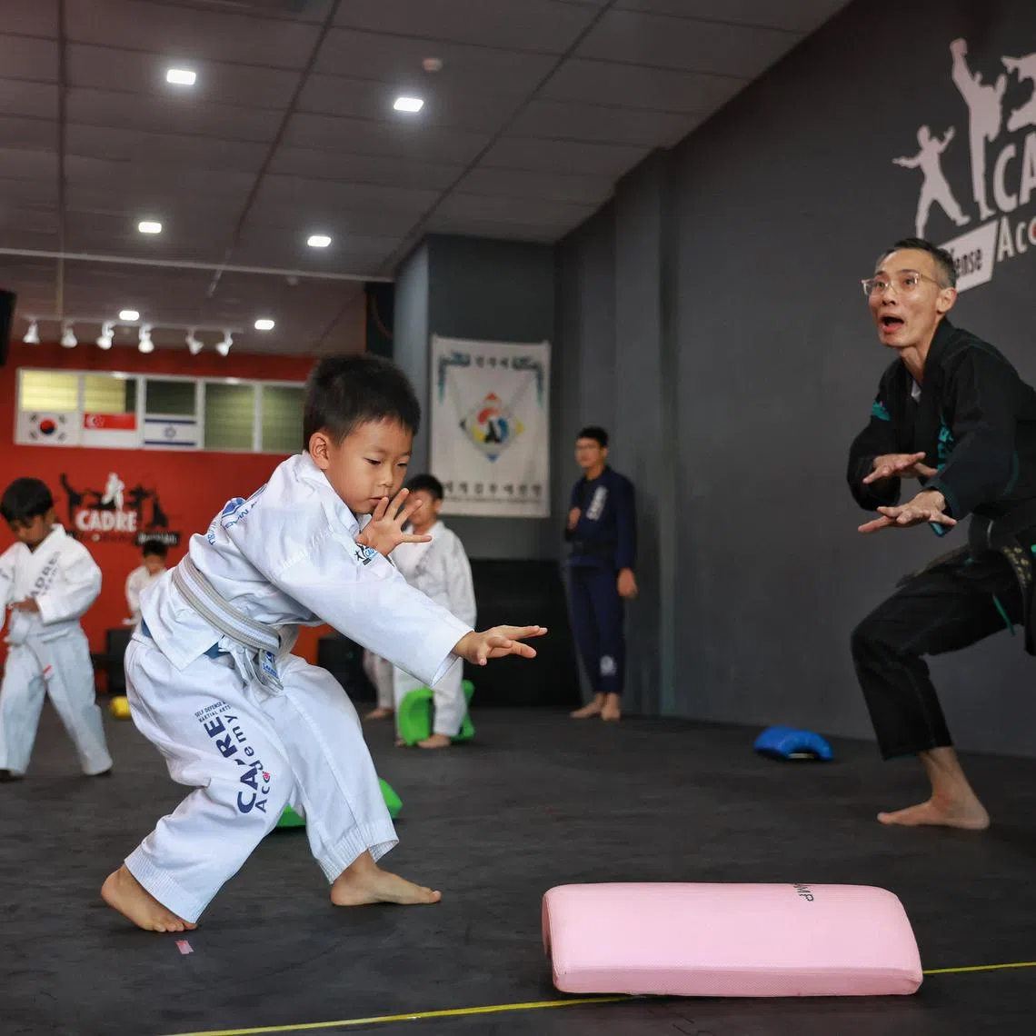 Six-year-old Oliver Pang practising Kapap Krav Maga under the guidance of Master Leon Koh (in black martial arts uniform), founder of Cadre Academy, on July 1, 2023.